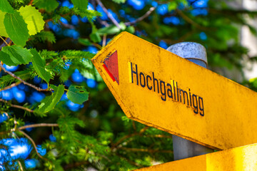 Yellow arrow location and hiking sign direction in Tyrol Austria.