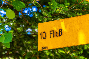 Yellow arrow location and hiking sign direction in Tyrol Austria.