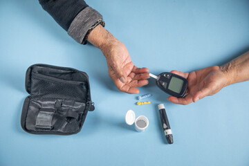 Elderly woman checking her blood sugar level.