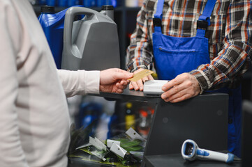 Customer paying with credit card at auto parts store