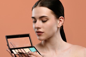Woman Applying Makeup with Palette and Brush