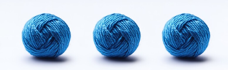 Three balls of vibrant blue yarn