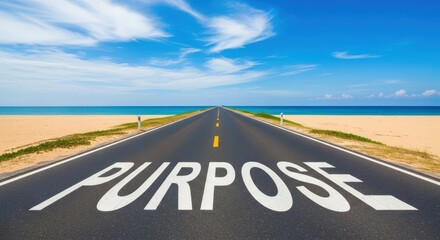 Open road leading to ocean with purpose painted on pavement beach sand