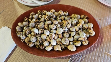 Traditional Portuguese Dish of Cooked Snails in Ceramic Bowl