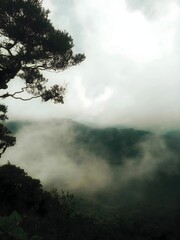 Foggy Mountain Landscape with Dramatic Cloud Cover