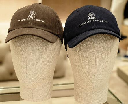 Hat with visor from Italian high-end brand by Brunello Cucinelli on sale at a boutique.Milan - Italy, July 02, 2025
