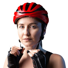 A young female cyclist wearing a safety helmet and glasses, dressed in a bib shorts poses against a...