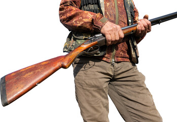Mature man hunter with gun while walking on field.