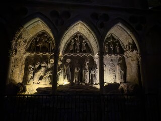Illuminated gothic stone sepulcher with sculptures inside Catedral de Leon