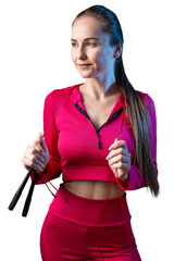 A young healthy girl in a sports top and leggings poses in the studio against a black background.