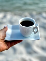 espresso cup on the beach