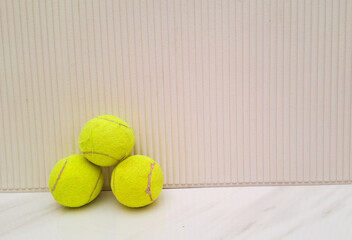 Tennis ball on white background on marble. Stacked tennis ball isolated on white background.
