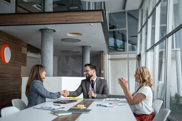 Business people shaking hands congratulating successful agreement in office meeting