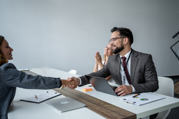 Business people shaking hands during a meeting in the office