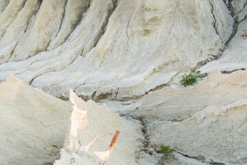 A mesmerizing close-up of a white sand quarry, revealing intricate erosion patterns, deep ravines,...