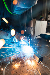 man weld a metal with a welding machine