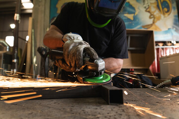 man polishes the metal angle grinder