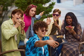 Group of young friends eating street food and taking selfie outdoors. Concept of carefree summer...