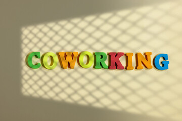 Coworking Concept Displayed With Colorful Letters in Geometric Shadow Light