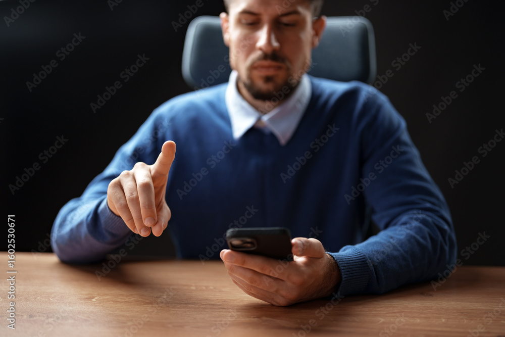 Poster man using smartphone while gesturing with his hand in a modern office setting during the day