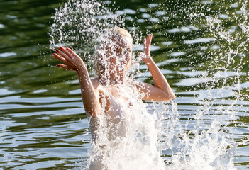 Woman in White Dress Playing with Water Splash Outdoors