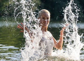 Woman in White Dress Playing with Water Splash Outdoors