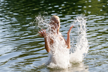 Woman in White Dress Playing with Water Splash Outdoors