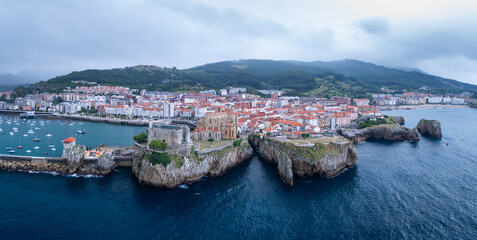 Obraz premium Aerial view from a drone of the Castro Urdiales port, the Church of Santa María, and the Santa Ana Castle Lighthouse. Castro Urdiales Municipality. Cantabrian Sea. Cantabria. Spain. Europe.