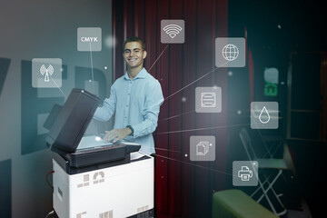 Young man using a multifunction printer to scan documents while discussing digital connectivity features in a modern workspace