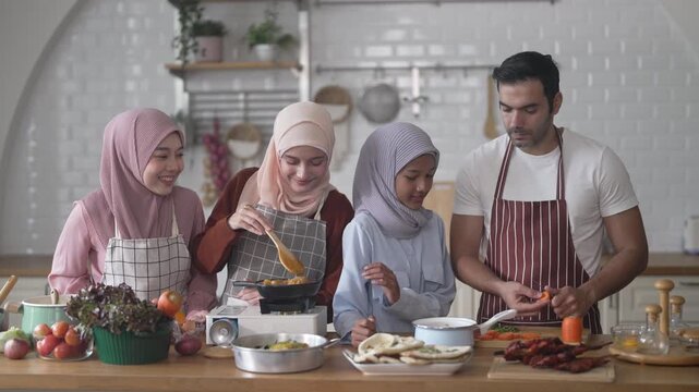 Muslim family cooking together in kitchen preparing food with fresh vegetables, islamic holiday gathering with fresh ingredients and family love, halal food preparation for ramadan or eid celebration