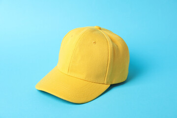Yellow baseball hat on light blue background