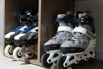 Pairs of roller skates in shelving unit, closeup