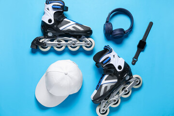 Flat lay composition with roller skates on blue background