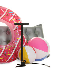 Inflatable ring, mattress, balls and manual air pump isolated on white
