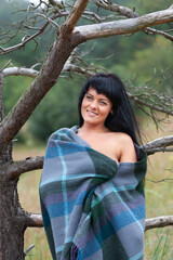Nude woman posing nude in nature background