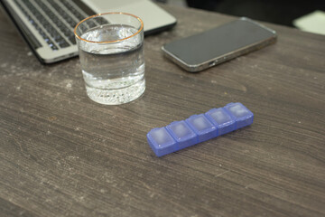 Healthy Workspace with Medication, Hydration, and Technology
