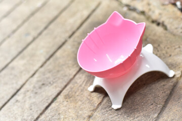Pink and White Cat Food Bowl on Concrete
