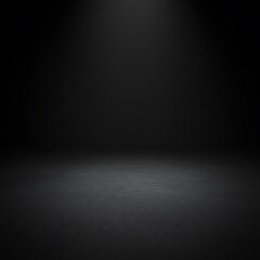 A dark, empty studio space with a concrete floor and black background.