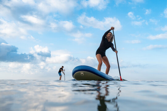 Focused woman enjoying a paddleboard challenge