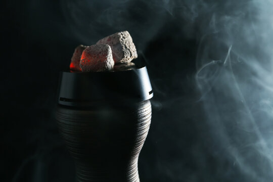 Smoldering charcoal cubes in hookah holder and smoke on dark background, closeup - Powered by Adobe