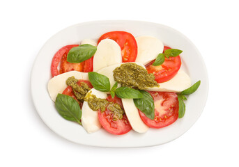 Tasty salad Caprese with mozzarella, tomatoes, basil and pesto sauce isolated on white, top view
