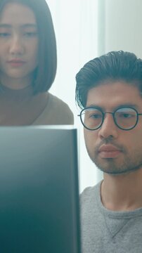 Vertical Screen : Group Adult Asia male female freelance meeting write prompt AI bot app program nomad, video game, talk strategy, discuss plan, user interface, designer, big data on desktop computer.