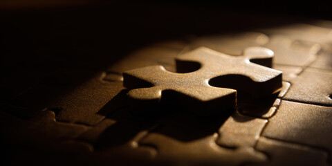 Single puzzle piece rests on nearly complete puzzle, symbolizing connection and completion