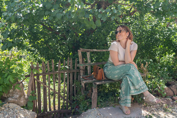 Attractive woman on a small bench by the road portrait outdoor