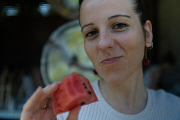 Woman eating watermelon and smiling