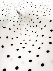 A detailed close-up of soft white satin fabric with classic black polka dots. Elegant, retro-style textile background for fashion or design use
