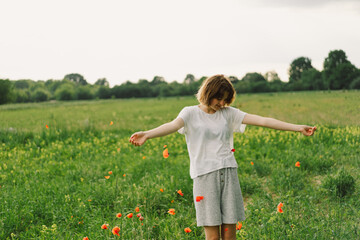 Portrait Of Teenage Girl. Happy Cheerful Teen Girl With Pronounced Face dancing In Outdoors in a...