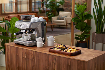 Silver espresso machine with cups and snacks coffee maker