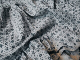 The motif and background of the fabric depict small flowers