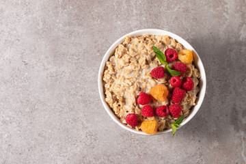 Delicious oatmeal porridge with raspberries and honey